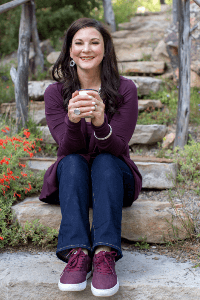 Dr. Penny on steps holding cup