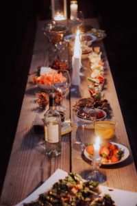 wood plank table with candles set for Thanksgiving